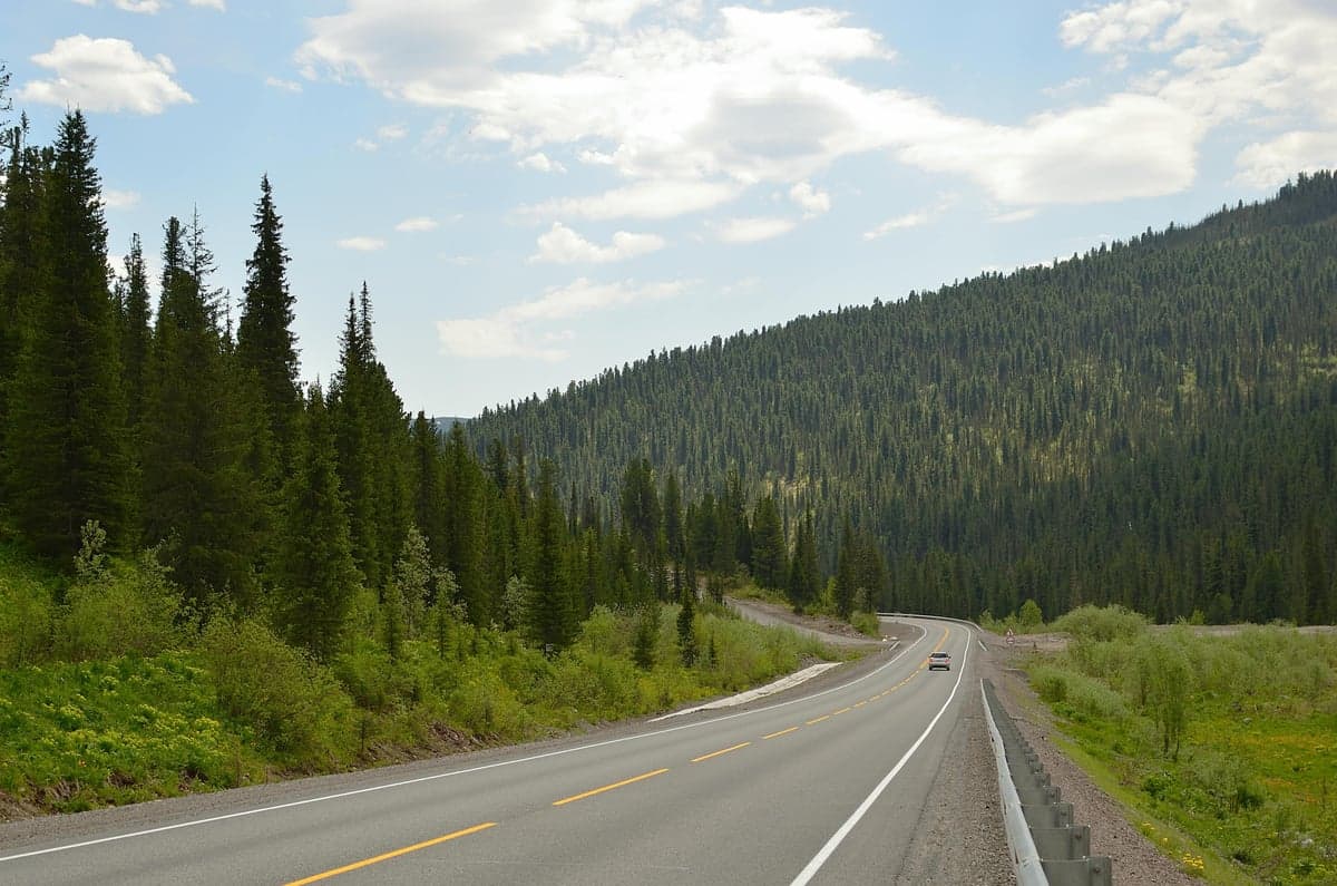 The drive to Dutch John climbs through conifer forests and mountain passes in the Uinta range before dropping into Flaming Gorge