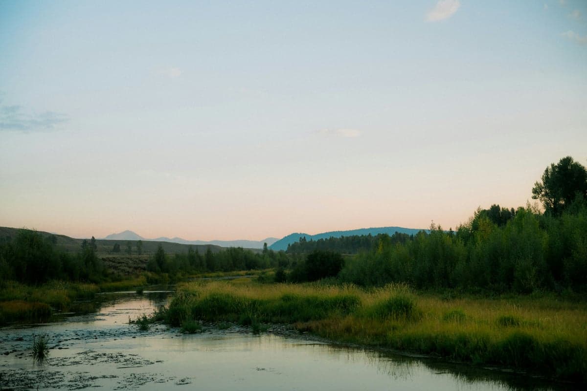 River winding through a grassy Wyoming valley at dusk