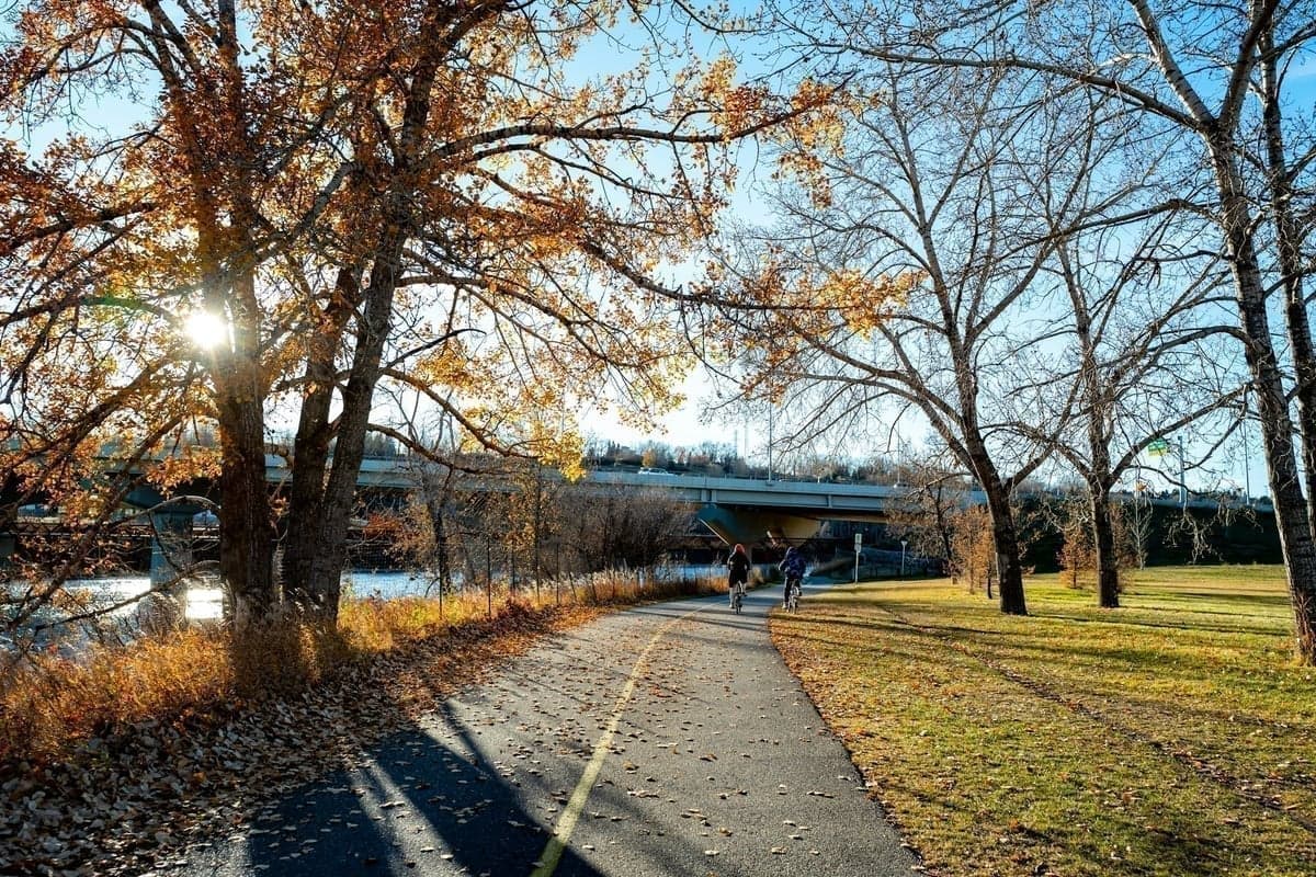 A bike path next to a river with a bridge in the background - exactly the kind of accessible water beginners should look for