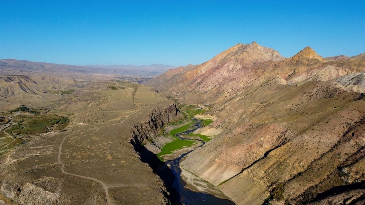 Angler fly fishing in a Pacific Northwest river canyon